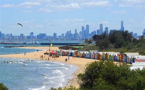 the beach is crowded with people and colorful umbrellas in front of the ...