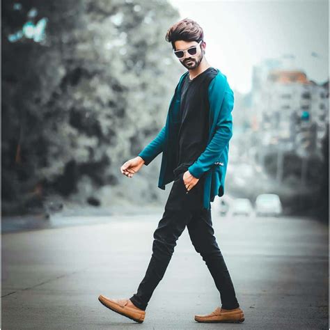 Download A Man In A Blue Cardigan Walking Down The Street | Wallpapers.com