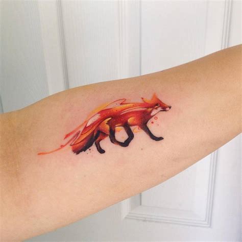 Watercolor style fox tattoo on the left forearm.