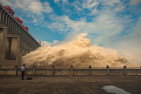 Thousands evacuated as floods threaten a massive dam and a treasured ...