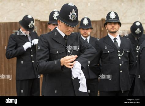 New Metropolitan Police officers check their uniforms before taking ...