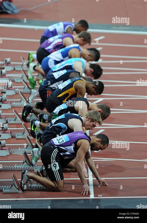 Sprinters in the starting blocks on a running track Stock Photo - Alamy