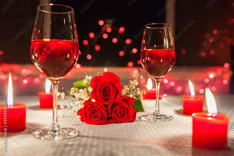 Romantic date night. Candle light dinner with roses and wine. Stock ...