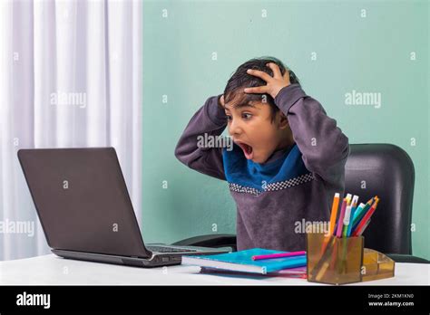 Shocked and surprised boy on the internet with laptop computer Stock ...