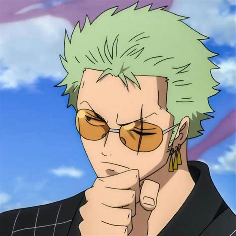 a man with green hair and glasses holding his hand up to his face while ...