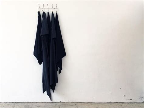 Premium Photo | Black clothes hanging on white wall