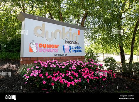 A logo sign outside of the headquarters of Dunkin' Brands Group, Inc ...