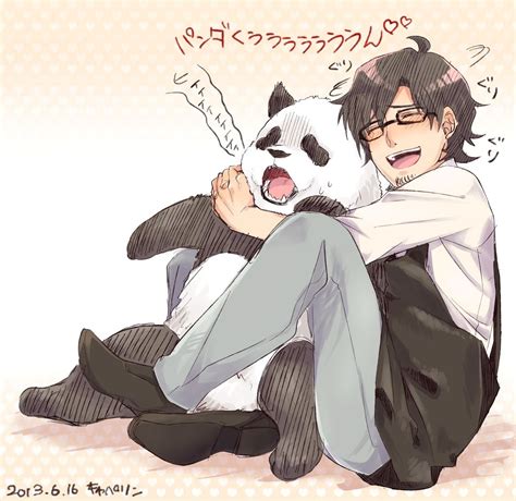 a man sitting on the ground with a panda bear in his lap and an ...