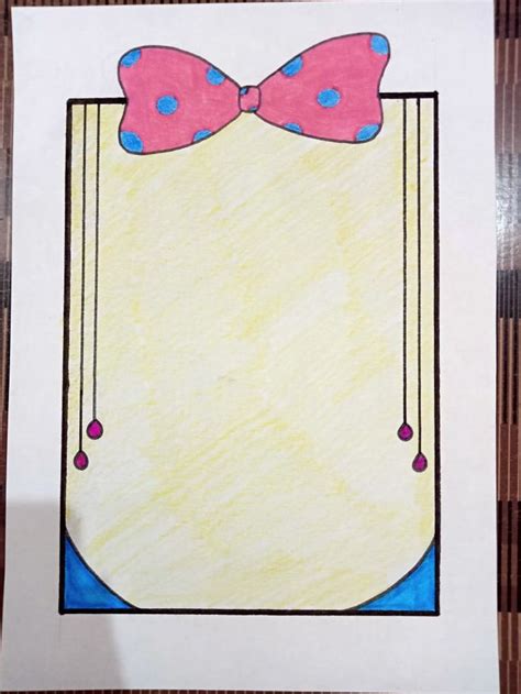 a drawing of a bow tie on top of a piece of paper with blue and pink dots