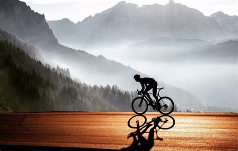 Download Road Bike Ride In Foggy Mountain Wallpaper | Wallpapers.com