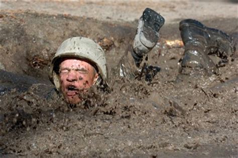 An Air Force Academy cadet trainee attacks the mud pit.