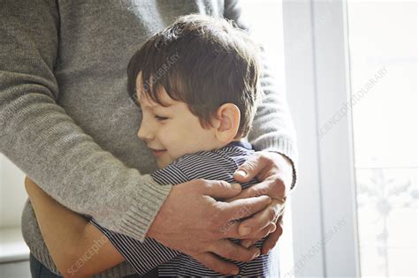 Father and son hugging - Stock Image - F011/2474 - Science Photo Library