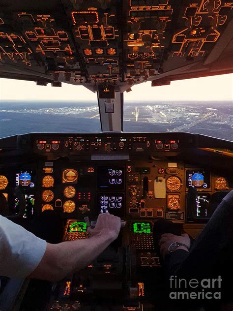 Cockpit view of commercial jet airplane landing on airport Photograph ...