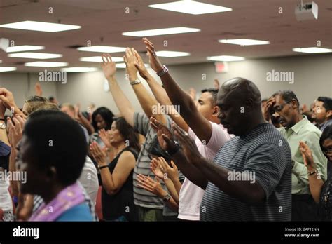 church congregation lifting hands in praise and worship and prayer ...