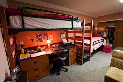 a bedroom with bunk beds and desk in it