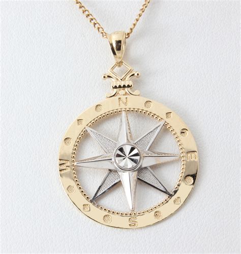 14K YELLOW GOLD AND RHODIUM COMPASS ROSE PENDANT | Newitt Jewelers