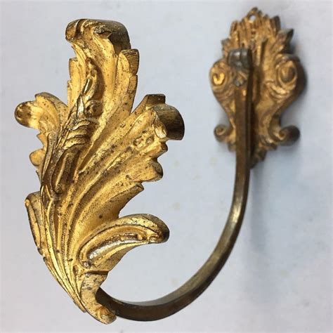 Pair of gilded brass curtain tie-backs | BADA