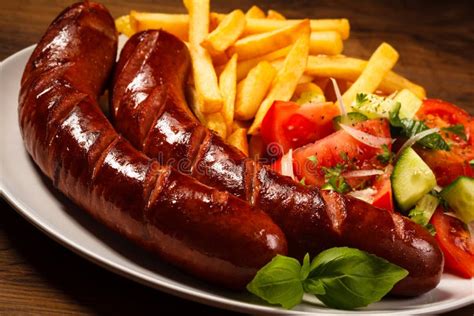 Grilled Sausages, Chips and Vegetable Salad Stock Image - Image of ...