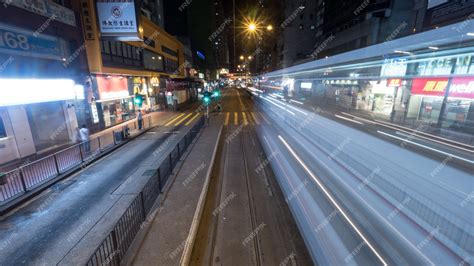 Premium Photo | Night hong kong street with rail and moving tram