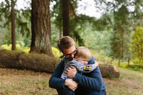 "Dad And Young Son Hugging" by Stocksy Contributor "Leah Flores" - Stocksy