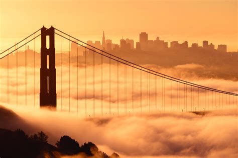 A dramatic view of the Golden Gate bridge covered in fog