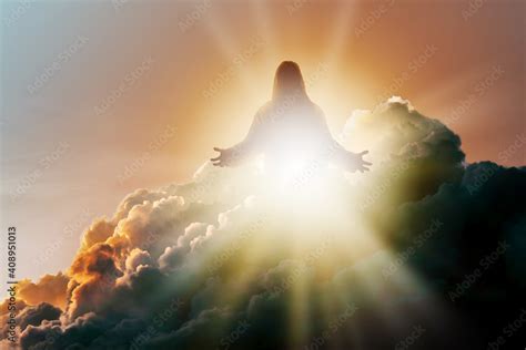 Silhouette of Jesus Christ in Heaven, up in the clouds against a bright ...