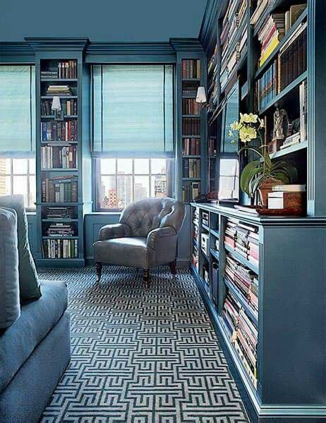 a living room filled with furniture and bookshelves covered in lots of ...