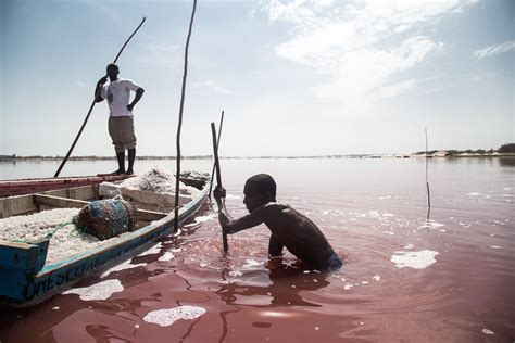 Lake Retba, Senegal Two men harvest salt in the pink waters of Lake ...