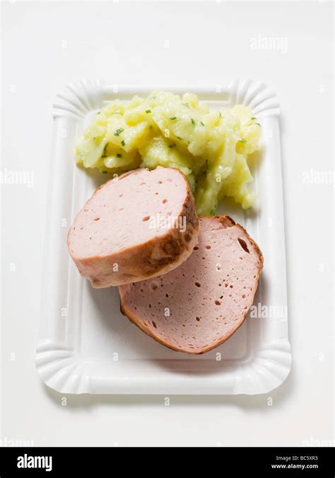 Leberkäse (type of meatloaf) with potato salad on paper plate Stock ...