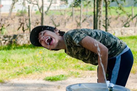 Premium Photo | Boy drinking water from fountain