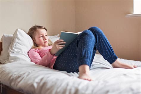 "Girl Reading A Book While Lying On A Bed" by Stocksy Contributor ...