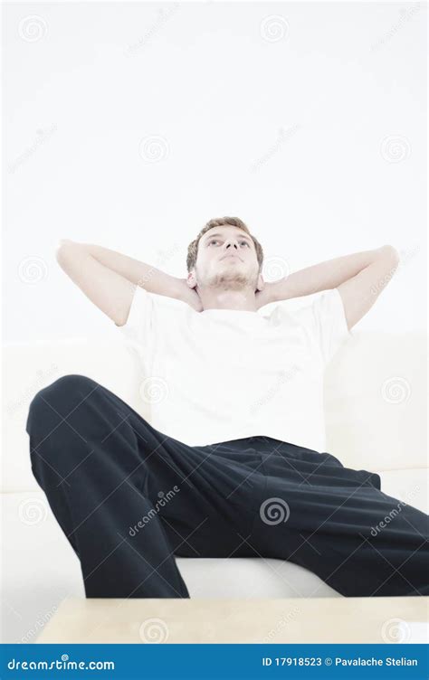 Young man resting on couch stock image. Image of people - 17918523