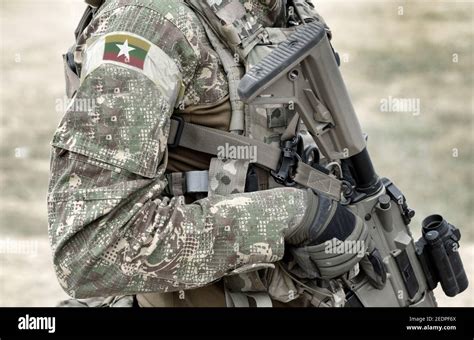 Soldier with assault rifle and flag of Myanmar and also known as Burma ...