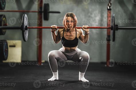 Woman Doing Squat Exercise At The Gym 14228788 Stock Photo at Vecteezy