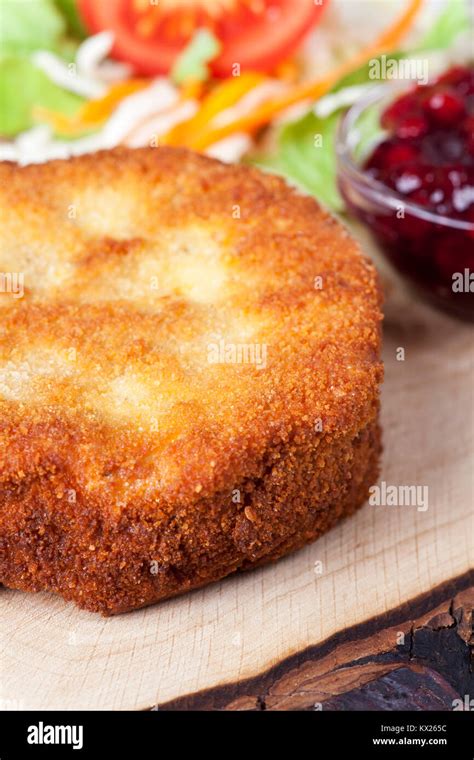 breaded camembert with salad on wood Stock Photo - Alamy