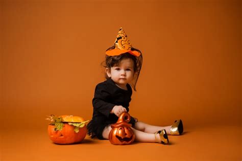 Premium Photo | Baby in a witch costume for halloween