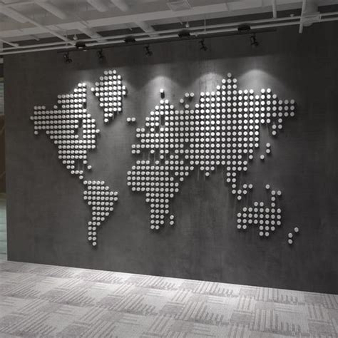 a large metal world map mounted to the side of a wall