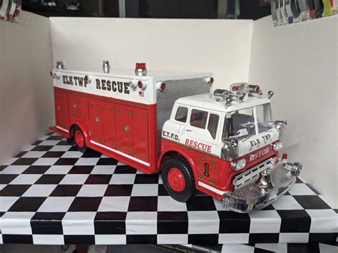 Red and White Fire Truck on Checkered Table