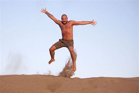 man jumping sand dunes in holidays | Sand dunes, Sand, Dune