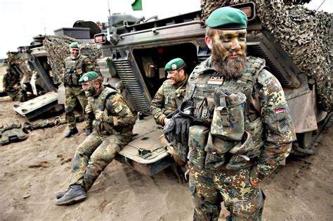 German armed forces, the Bundeswehr, stand next to their Marder light ...