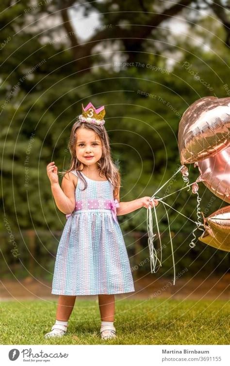 little girl blowing out the candles on a birthday cake - a Royalty Free ...