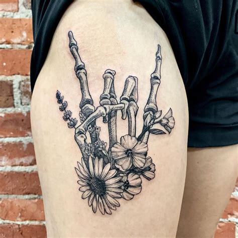 Skeleton Hand Holding Flowers Tattoo