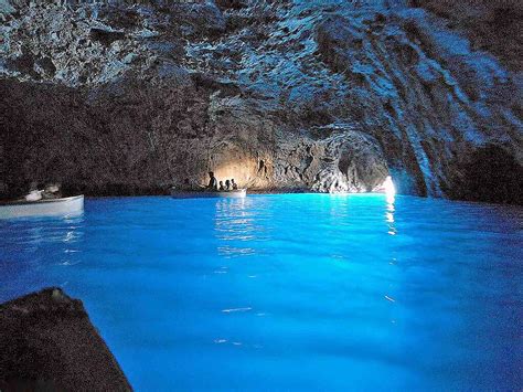 The Blue Grotto in Capri is a cave lit up by its mostly underwater ...