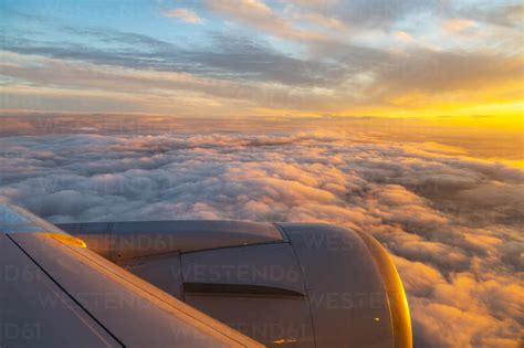 Generic view from airplane window of airplane wing and sunrise over ...