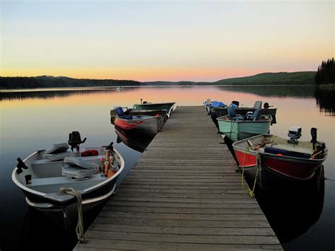 Fishing Boats Line Dock At Sunset by Wildroze