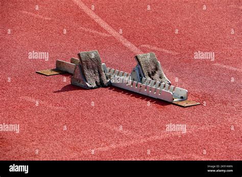 Sprinters starting blocks on athletics track Stock Photo - Alamy