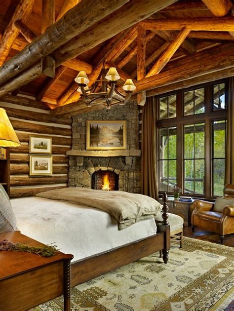 The master bedroom of this mountain cabin home has a beautiful rustic ...