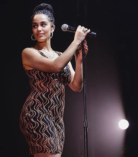 a woman in a short dress holding a microphone