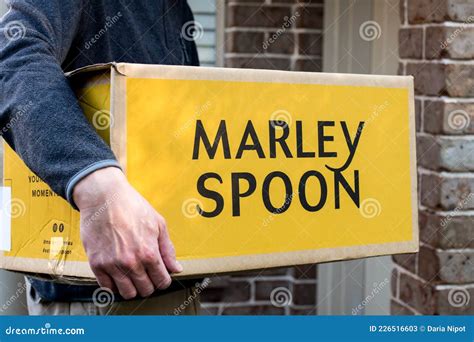 Delivery Man Holding Marley Spoon Meal Kits in a Box Near the Front ...