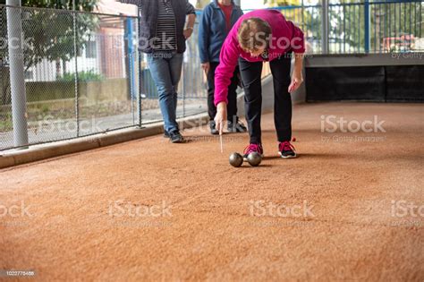 Senior Woman Marking Where Bocce Ball Has Stopped Stock Photo ...